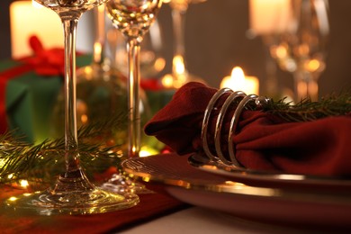 Photo of Christmas place setting with festive decor on table, closeup