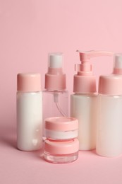 Photo of Cosmetic travel on pink background. Bath accessories