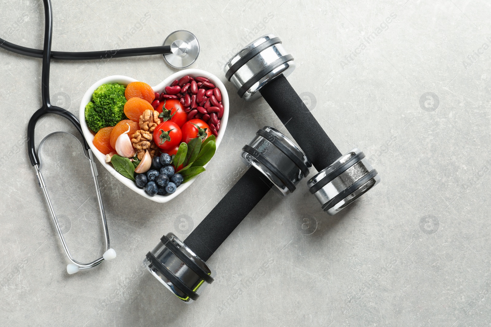 Photo of Flat lay composition with bowl of heart-healthy diet products and space for text on grey background
