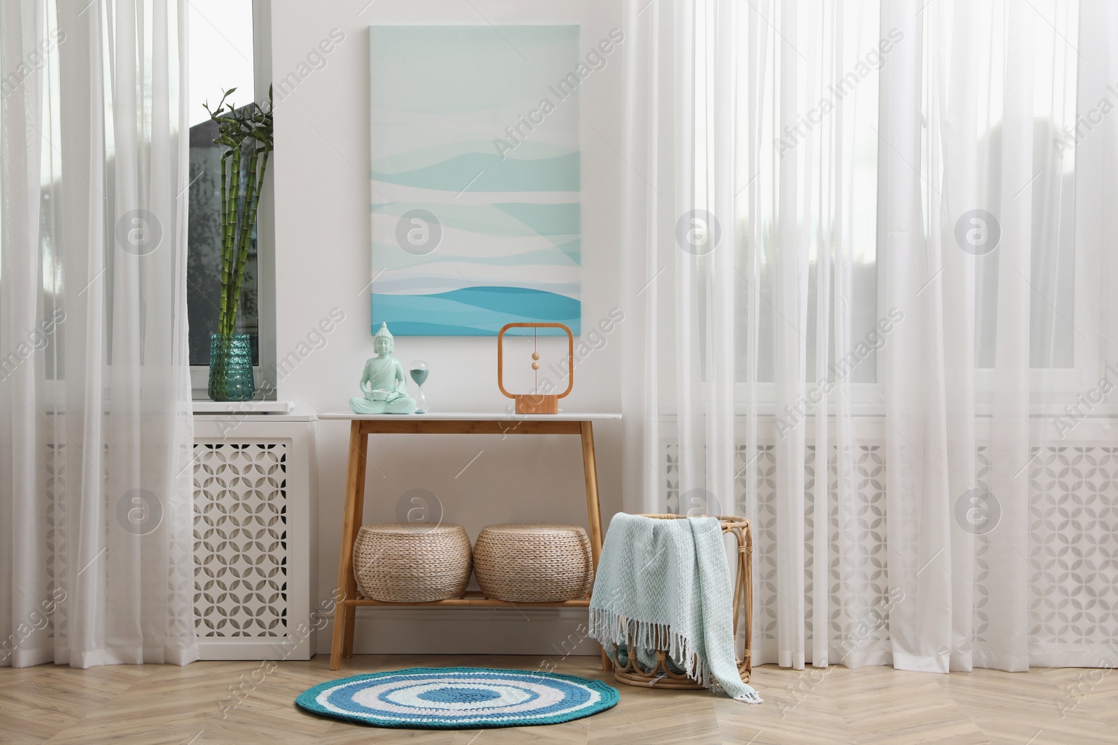 Photo of Console table with decor near light wall indoors. Interior design