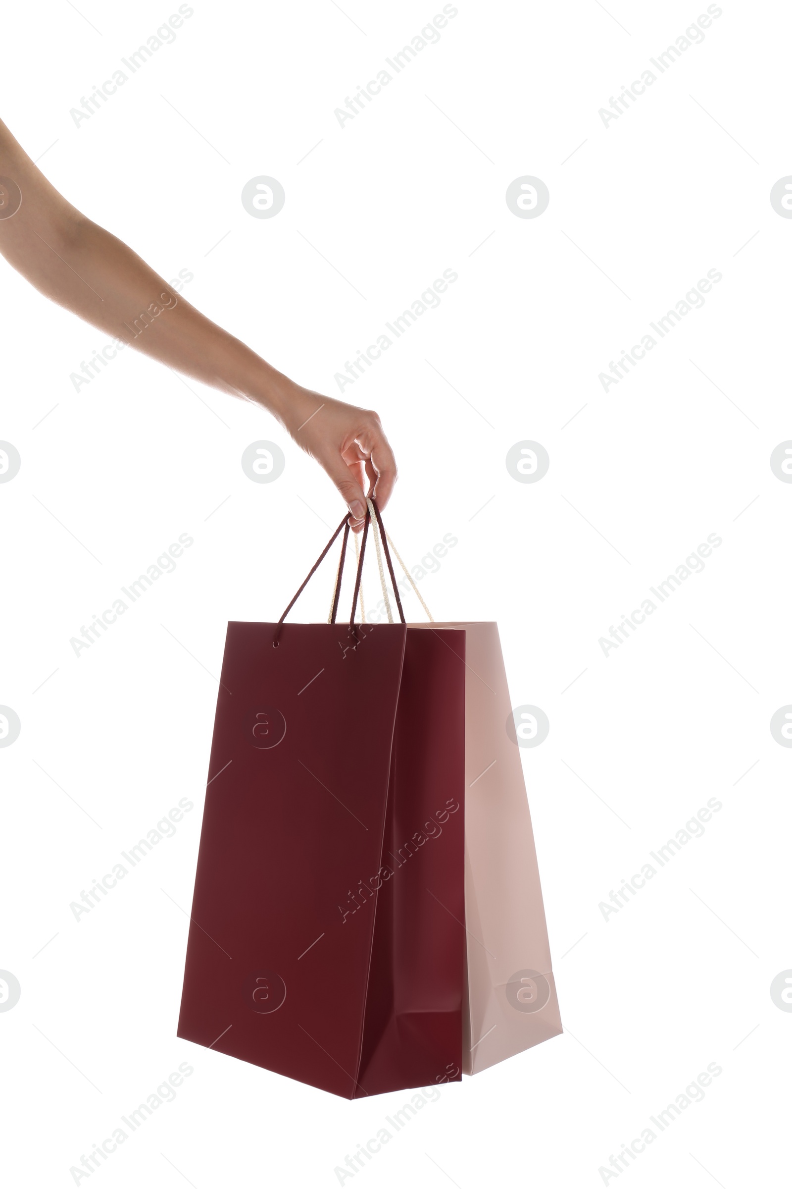 Photo of Woman with paper shopping bags on white background, closeup