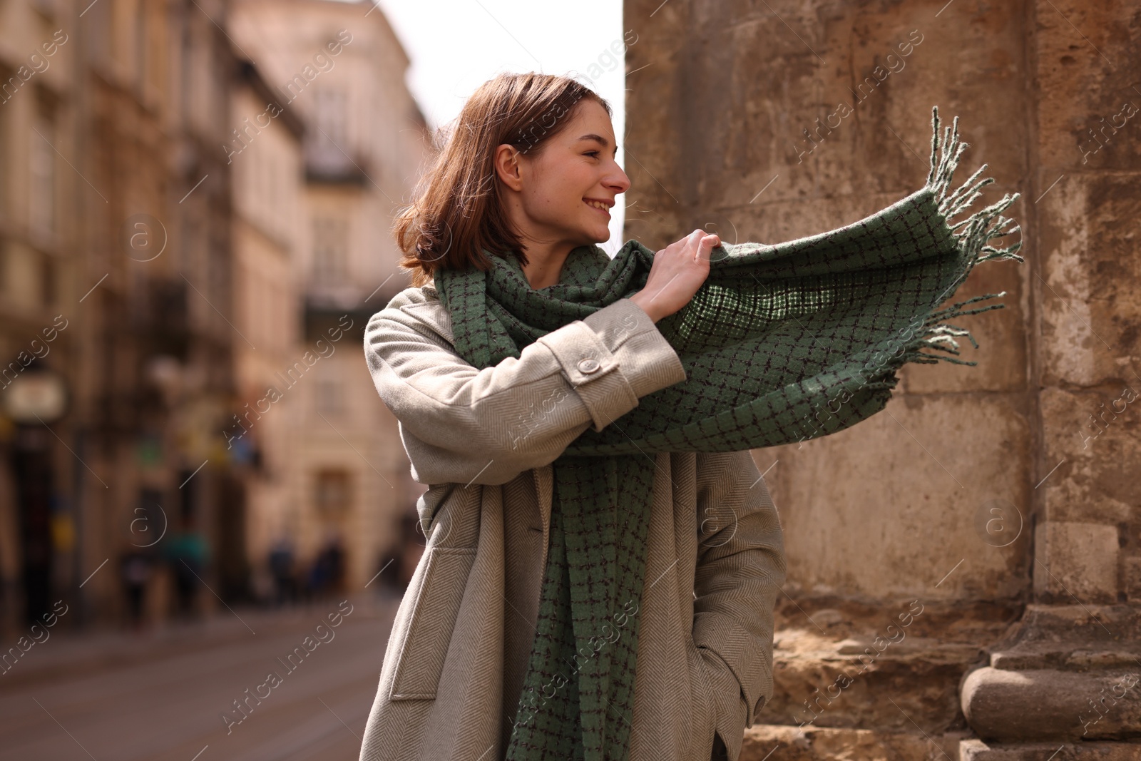 Photo of Beautiful woman in warm scarf on city street