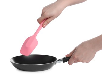 Photo of Woman with spatula and frying pan on white background, closeup