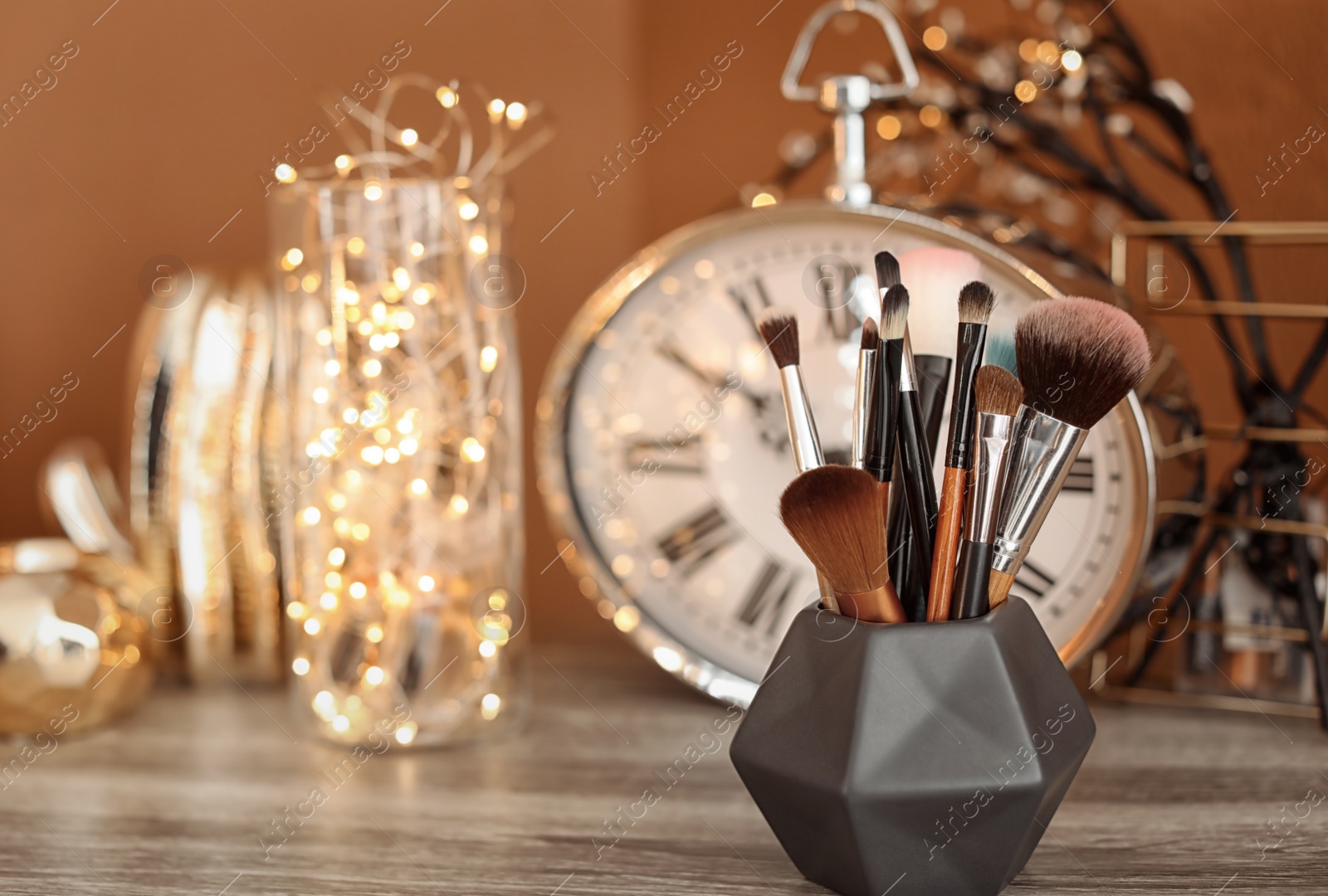 Photo of Holder with makeup brushes on table