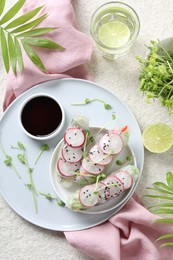 Photo of Delicious spring rolls served on light grey table, flat lay