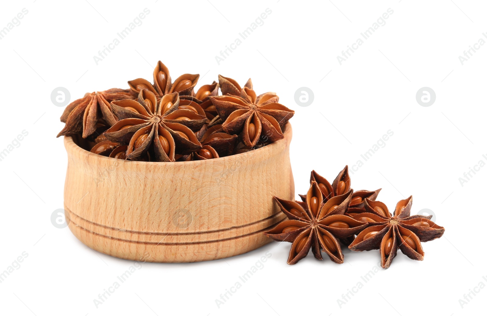 Photo of Wooden bowl and dry anise stars on white background