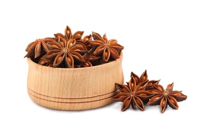 Photo of Wooden bowl and dry anise stars on white background