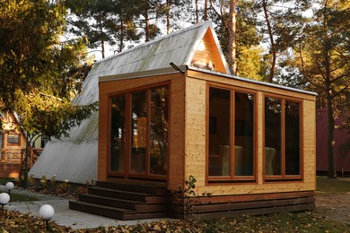 Photo of Picturesque view of modern wooden house in forest