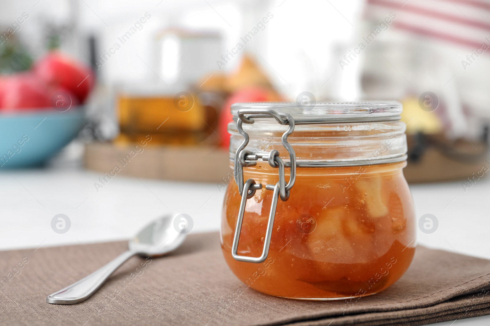 Photo of Delicious apple jam in jar on table, closeup. Space for text