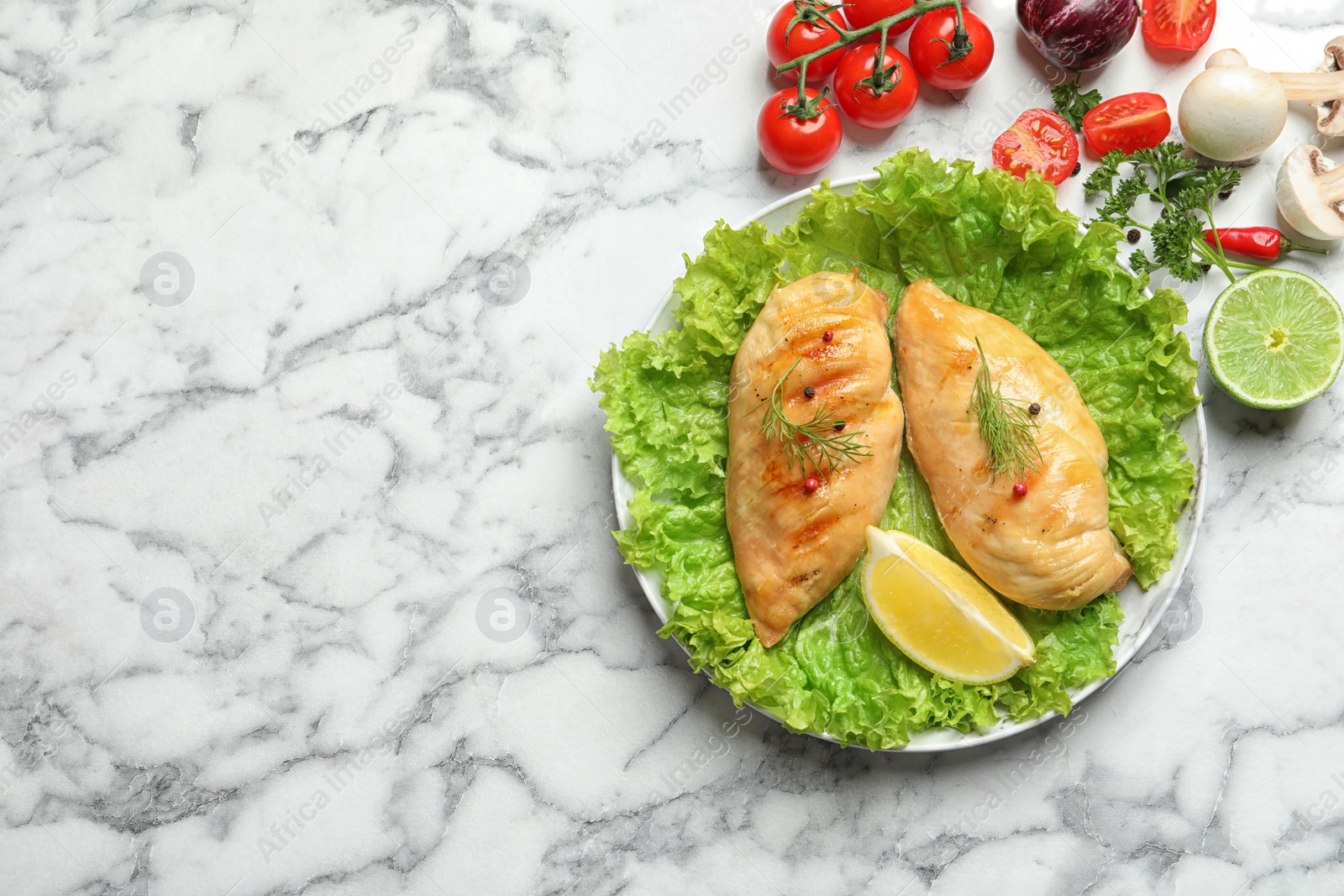 Photo of Grilled chicken breasts served on marble table, flat lay. Space for text