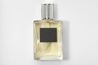 Photo of Luxury men's perfume in bottle on white background, top view