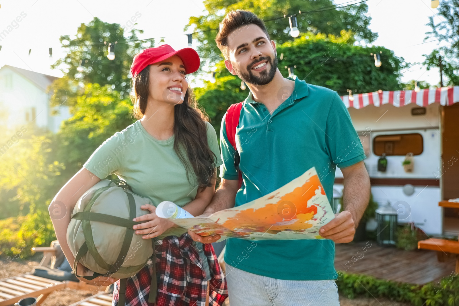 Photo of Young travelers with map planning trip outdoors