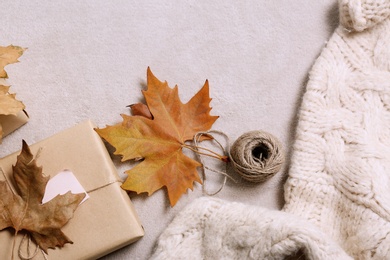 Photo of Flat lay composition with warm sweater on gray background