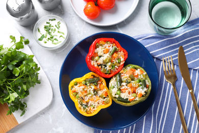 Photo of Tasty stuffed bell peppers served on grey table, flat lay