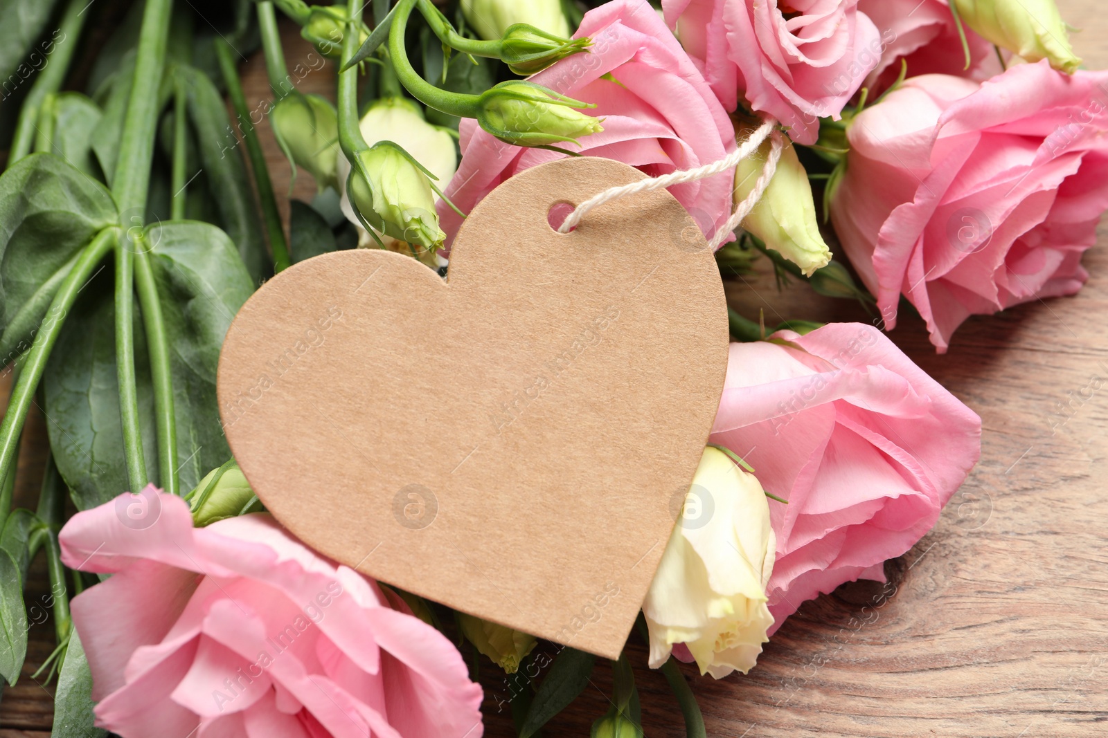 Photo of Happy Mother's Day. Beautiful flowers and blank heart shaped card on wooden table, closeup