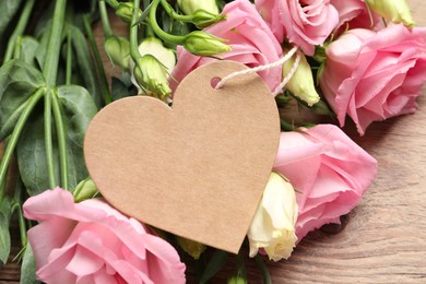 Photo of Happy Mother's Day. Beautiful flowers and blank heart shaped card on wooden table, closeup