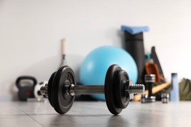 Photo of Dumbbell and other sports equipment indoors, closeup