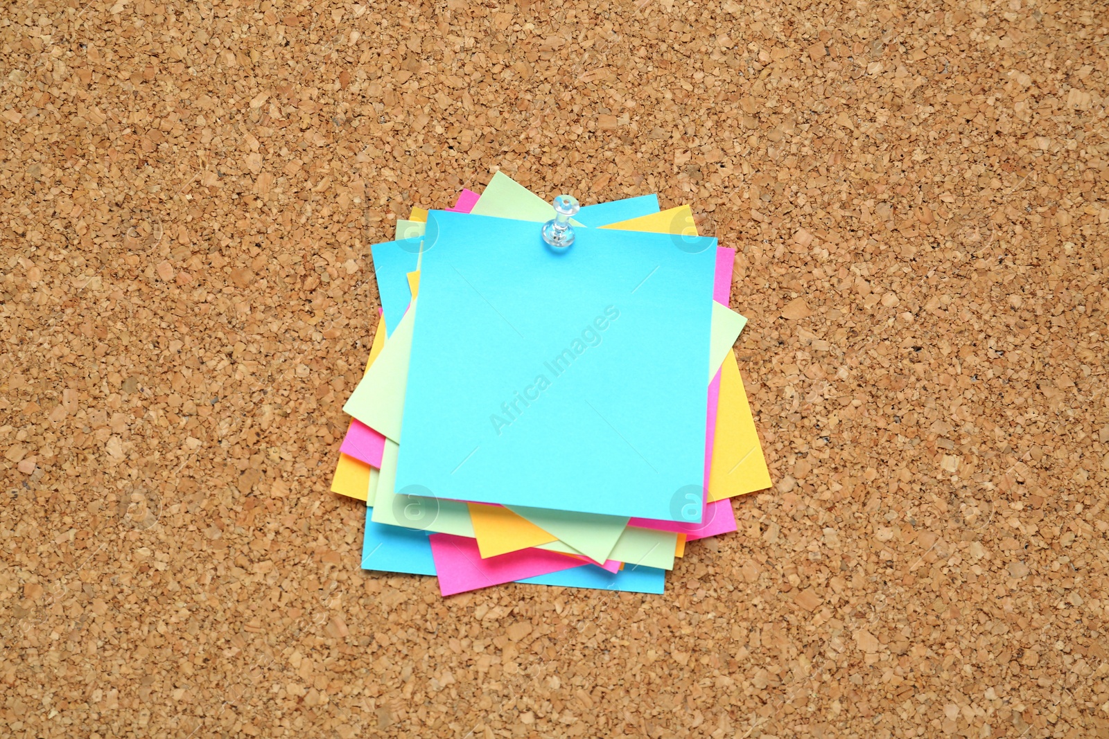 Photo of Many colorful notes pinned to corkboard. Space for text