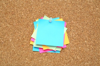 Photo of Many colorful notes pinned to corkboard. Space for text