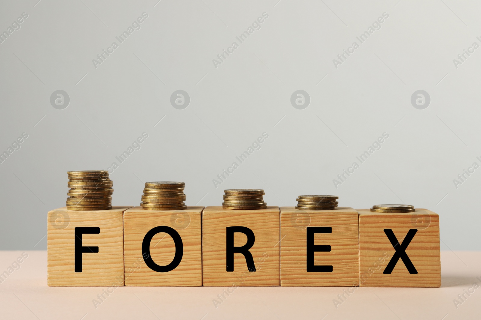 Photo of Word Forex made with wooden cubes and coins on white table