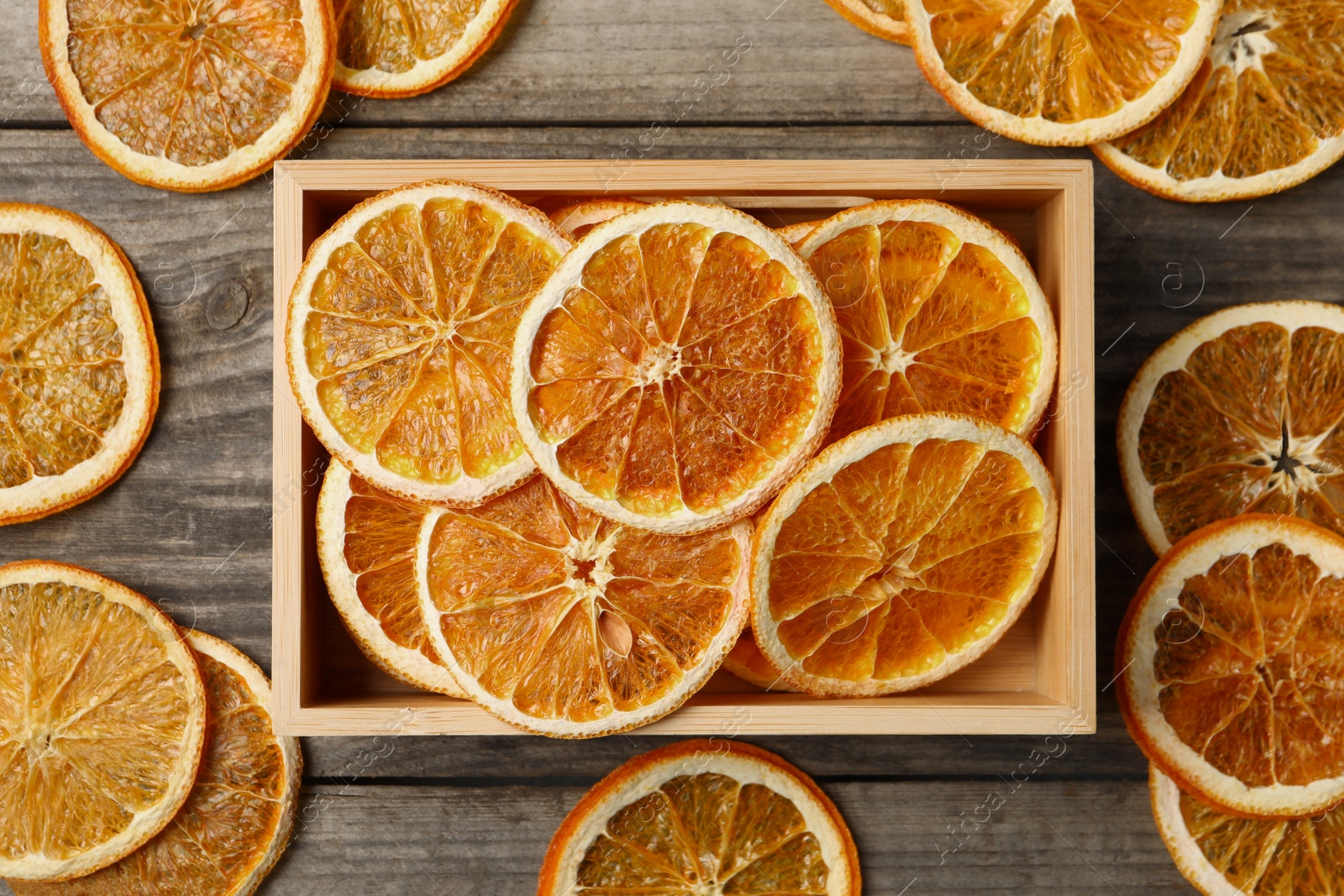 Photo of Dry orange slices on wooden table, flat lay