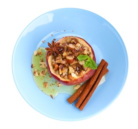 Tasty baked apple with nuts, honey, spices and mint isolated on white, top view