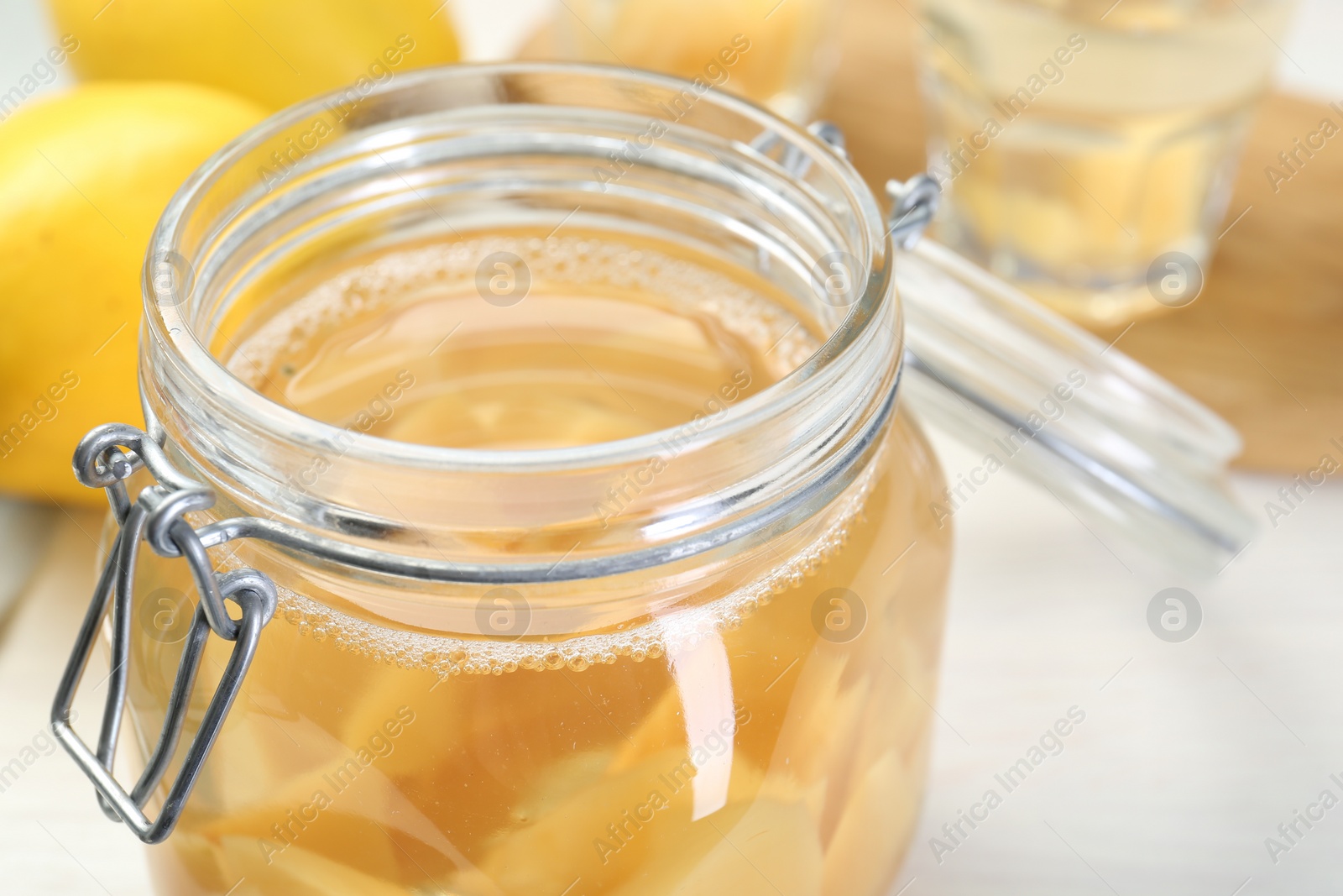 Photo of Delicious quince drink in glass jar on table, closeup