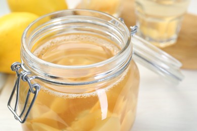 Photo of Delicious quince drink in glass jar on table, closeup