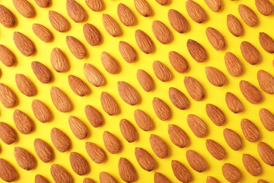 Photo of Composition with organic almond nuts on color background, top view