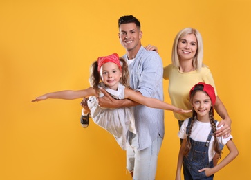 Photo of Portrait of happy family on yellow background