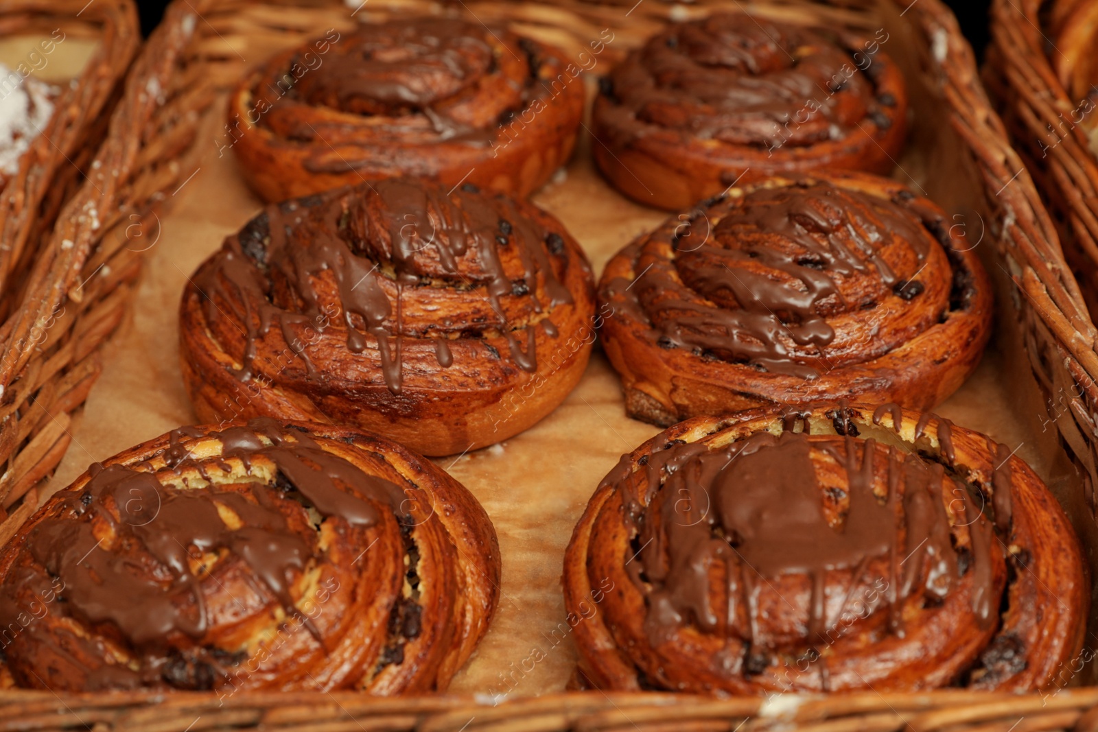 Photo of Sweet buns with chocolate in tray, closeup. Bakery products
