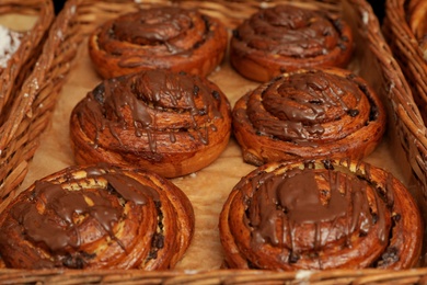 Sweet buns with chocolate in tray, closeup. Bakery products