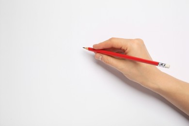 Woman with new graphite pencil on white background, closeup. Space for text