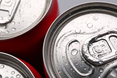 Photo of Energy drinks in wet cans, closeup. Functional beverage