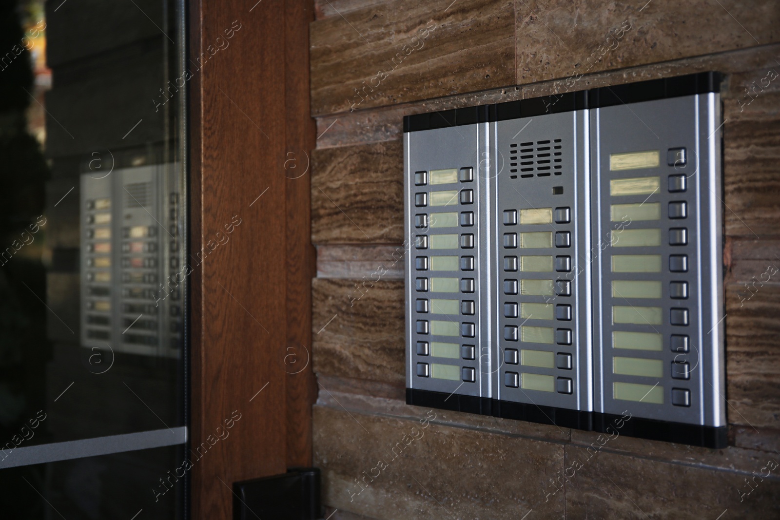 Photo of Modern intercom system on stone wall, space for text. House security