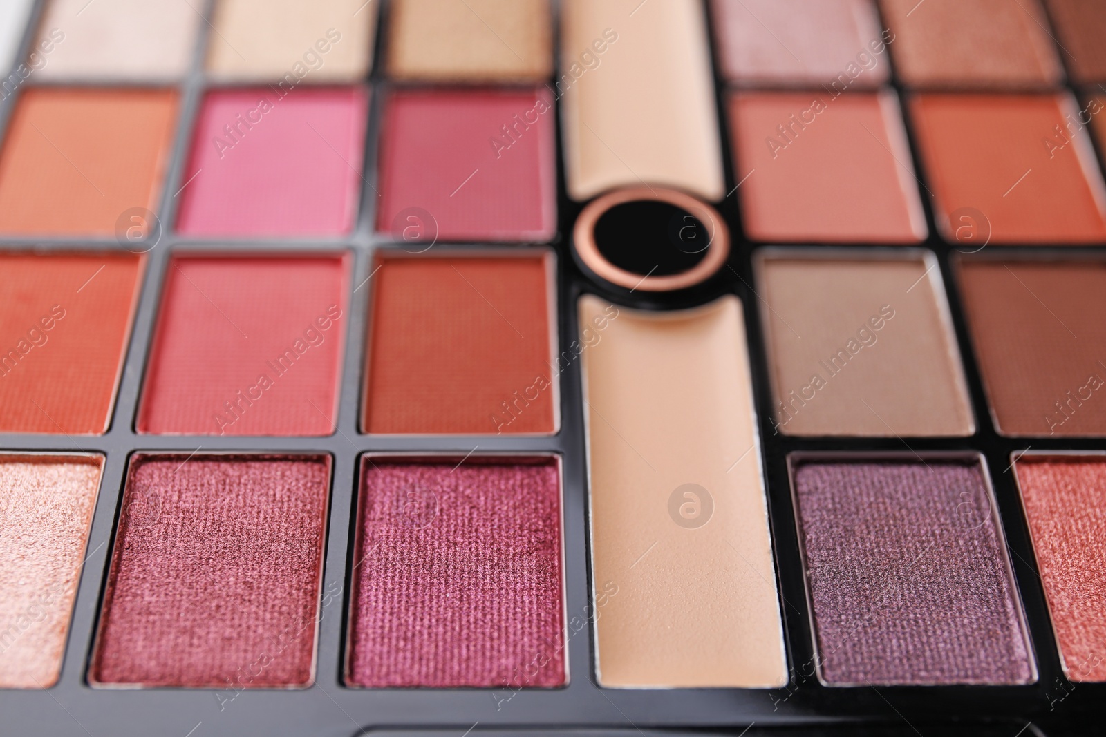 Photo of Beautiful eyeshadow palette as background, closeup. Professional cosmetic product