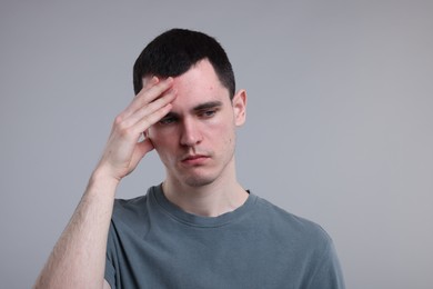 Photo of Portrait of sad man on grey background