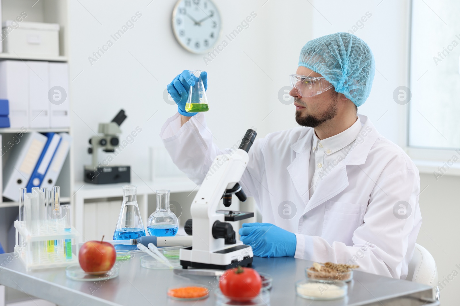 Photo of Quality control. Food inspector checking safety of products in laboratory