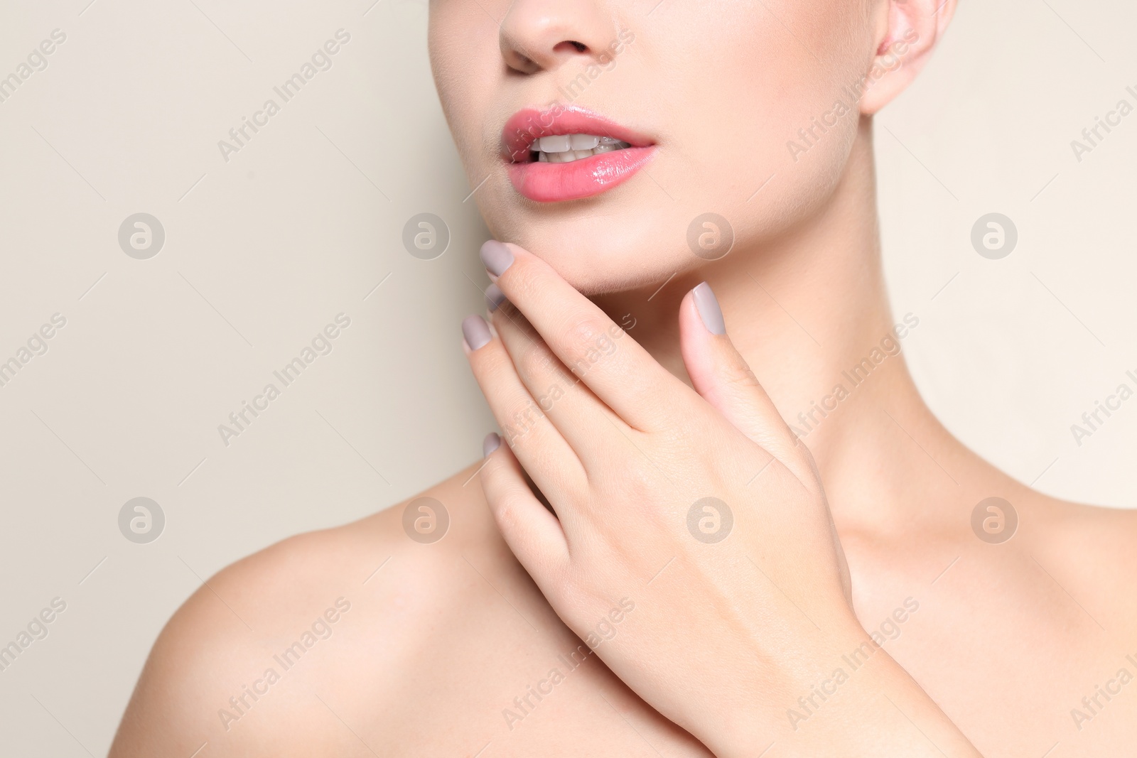 Photo of Beautiful young woman with perfect lips makeup on light background, closeup