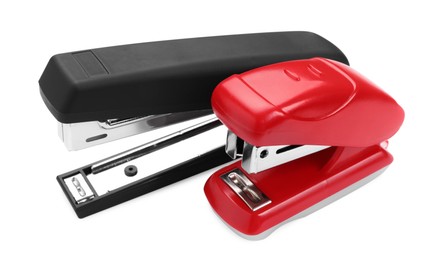 Photo of Two new bright staplers isolated on white, closeup