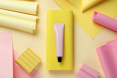 Photo of Flat lay composition with tube of cream on beige background