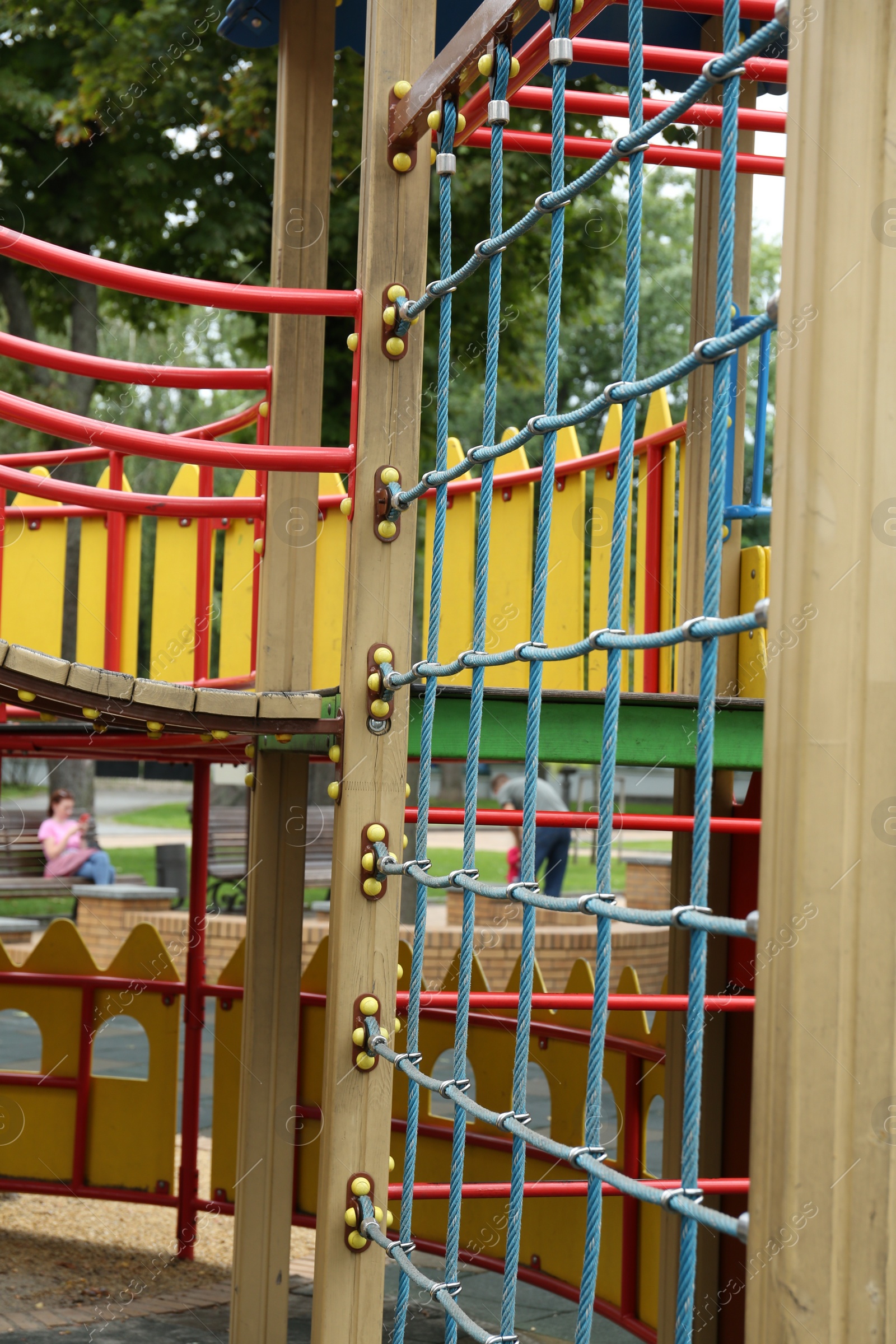 Photo of Children's playground with climbing rope net on summer day