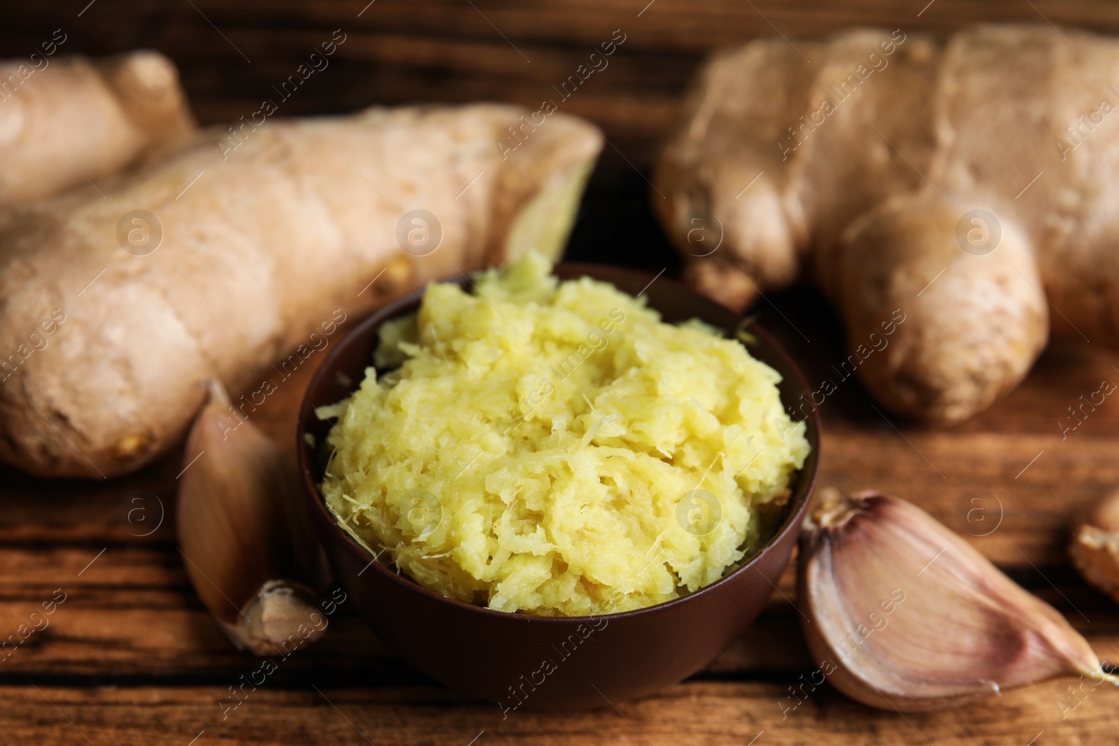 Photo of Fresh garlic and other natural cold remedies on wooden table