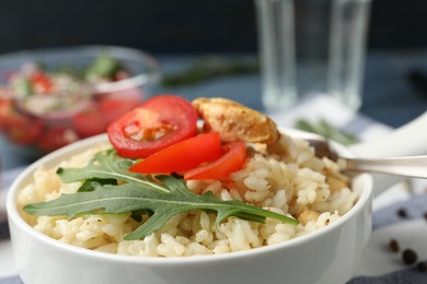 Photo of Delicious chicken risotto served in bowl, closeup
