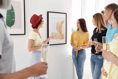 Photo of Group of people with guide at exhibition in art gallery