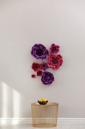 Photo of Stylish room interior with floral decor and golden table