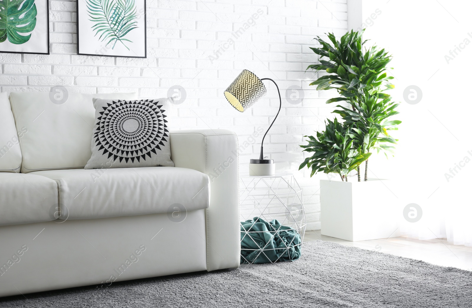 Photo of Comfortable white sofa in modern room. Interior design