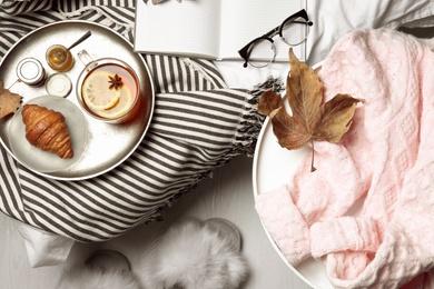 Flat lay composition with pink sweater on white table at home