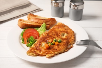 Photo of Omelet with vegetables on plate served for breakfast