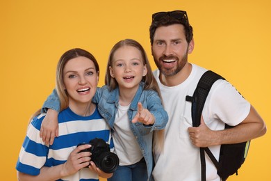 Photo of Happy family with camera on orange background